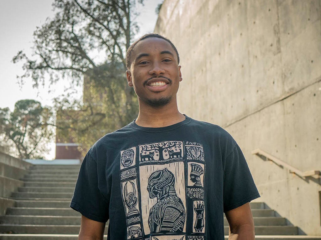 A portrait of Nate Walker standing on one of the many staircases at the Social Sciences Building on the ֱ campus