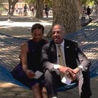 Chancellor May and LeShelle sitting in a hammock in the ֱ quad