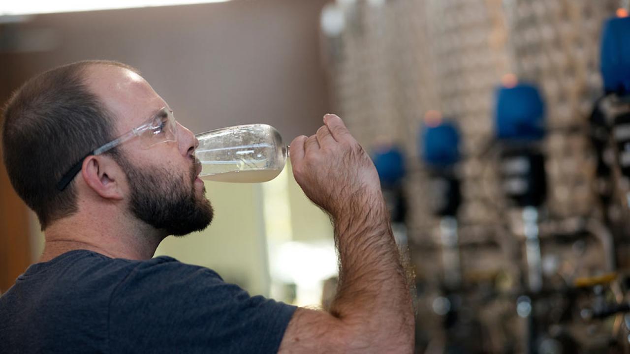 A ֱ student sips his own ale creation in beer making class