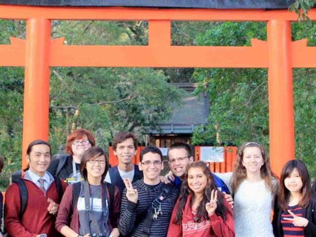 ֱ students pose in front of a shinto shrine in japan.