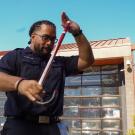 Abiel Malepeai with his fraternity cane outside the ֱ Fire Department.