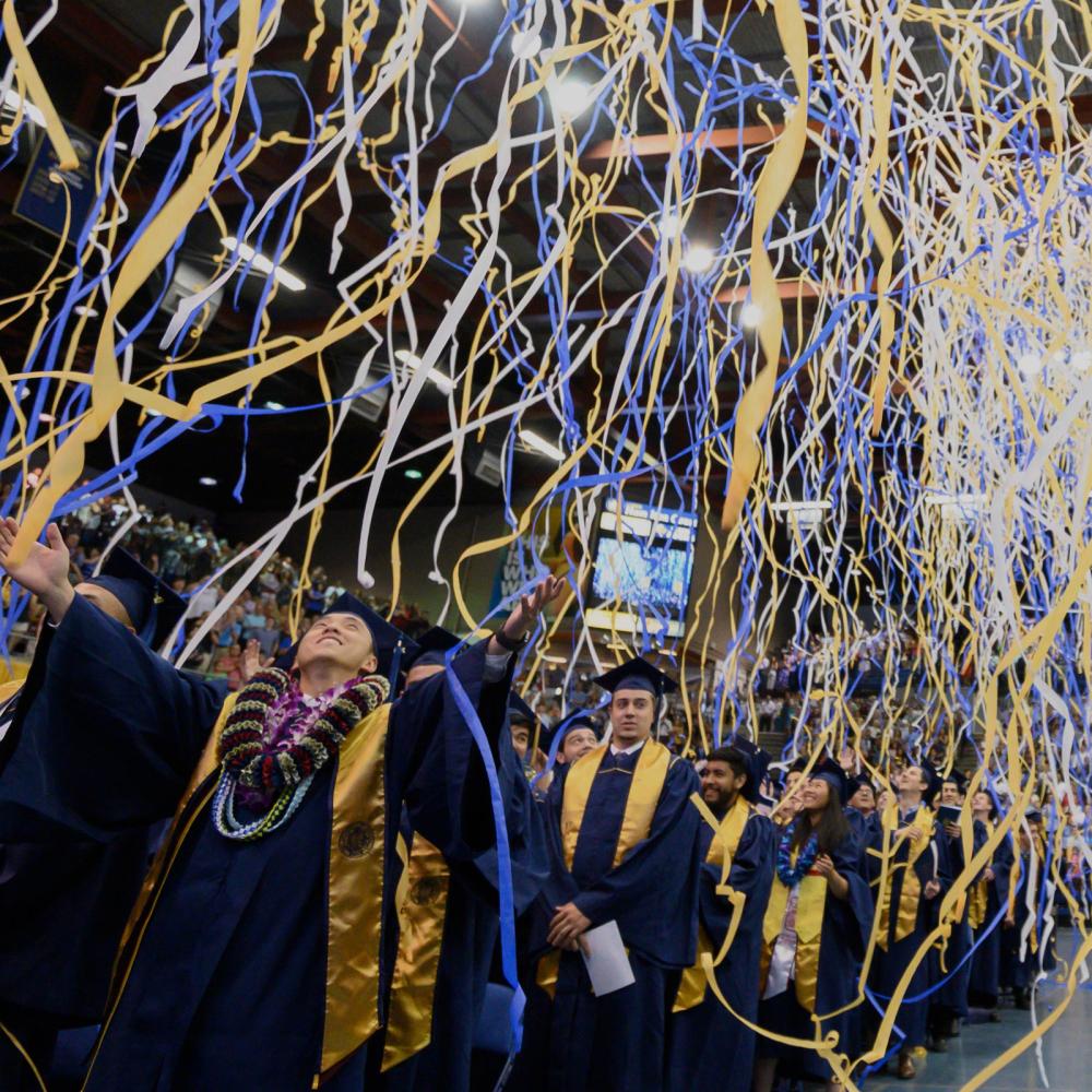 Streamers fall from the ceiling at the ֱ Commencement ceremony