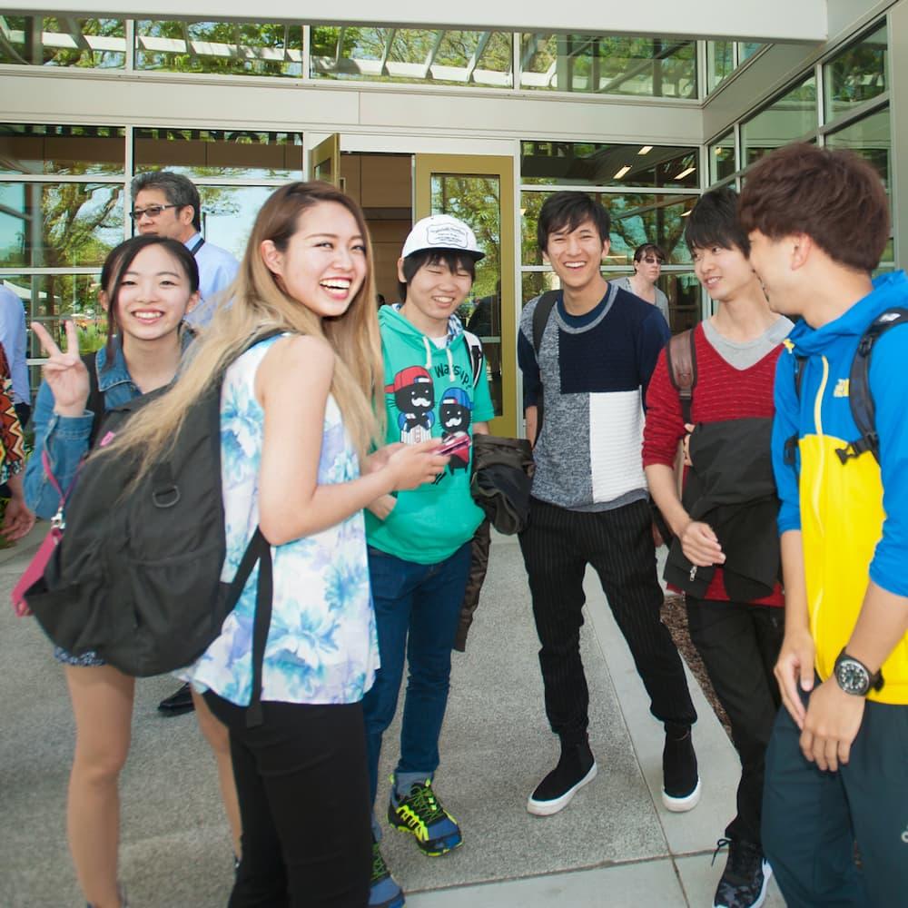 International students standing in front of the international center at ֱ.